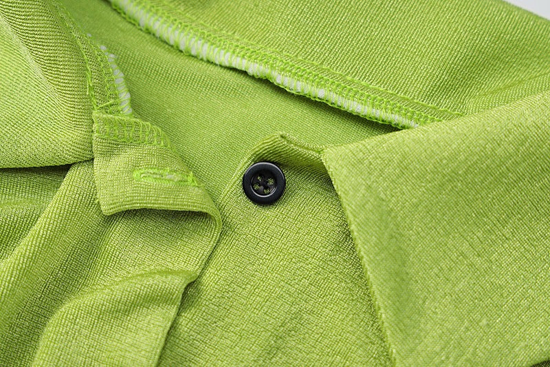 A polyester shirt in shades of black, green and white with long sleeves. It comes in 3 sizes S, M and L.