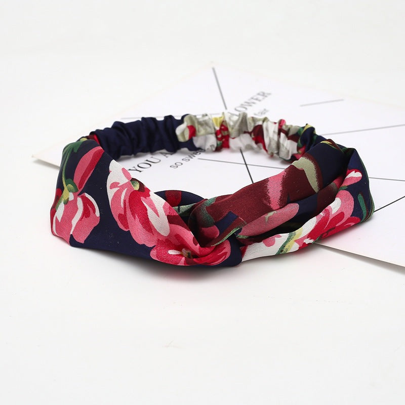 Introducing  Foretold - The Nevermore Boho Headband. This women's headband is crafted from fabric, featuring a stylish cross design. Perfect for various occasions, including weddings, travel souvenirs, and employee benefits, it adds a touch of elegance to your ensemble. The pattern incorporates a charming plaid motif, making it a versatile and fashionable accessory.