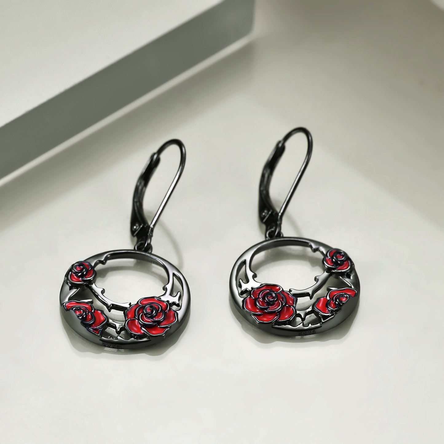 The earrings are made from high-quality sterling silver, which ensures that they will last for a long time and maintain their shine and beauty. The red rose design is intricately detailed and adds a touch of elegance to the overall gothic look of the earrings.