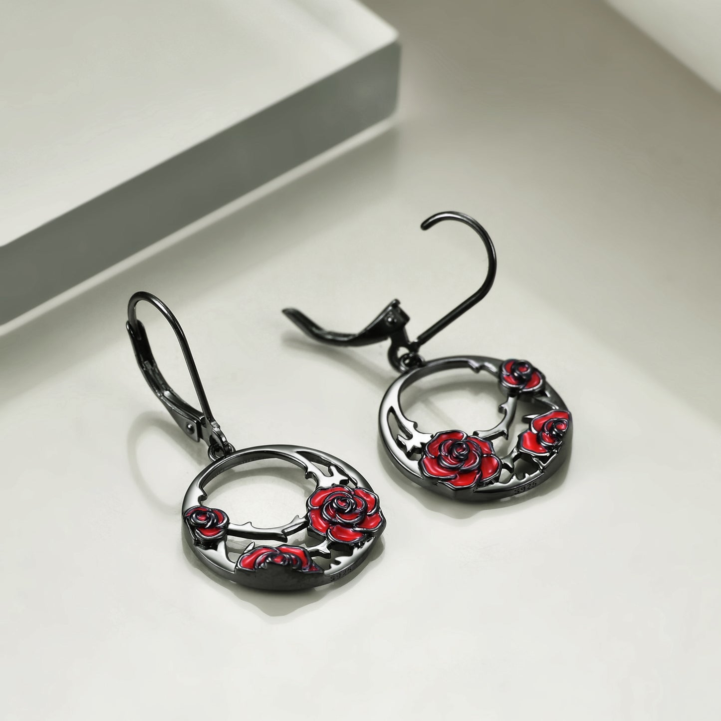 The earrings are made from high-quality sterling silver, which ensures that they will last for a long time and maintain their shine and beauty. The red rose design is intricately detailed and adds a touch of elegance to the overall gothic look of the earrings.