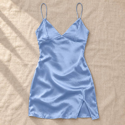 Blue Amari Combs satin mini slip dress laid flat on a beige fabric surface.