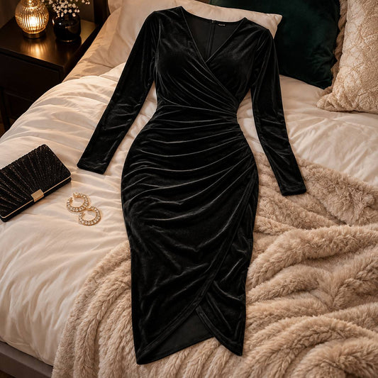 Amory black velvet midi dress arranged on a styled bed in an elegant bedroom.