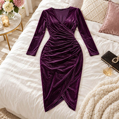 Amory purple velvet midi dress arranged on a styled bed in an elegant bedroom.
