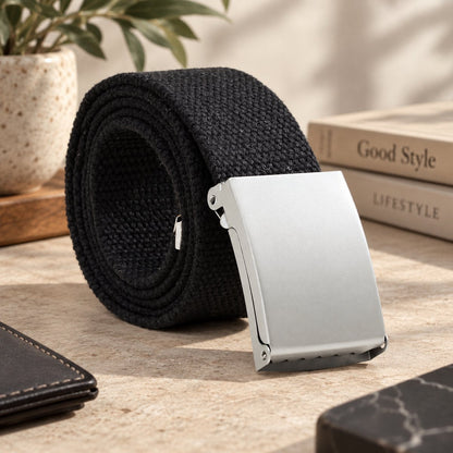 Black woven belt arranged in a coil with its silver buckle facing forward.