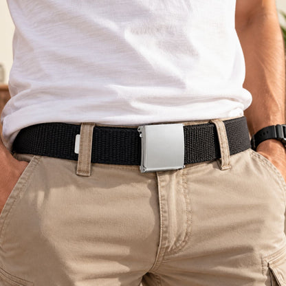 Black woven belt with a silver buckle, worn with a white T-shirt and beige trousers.