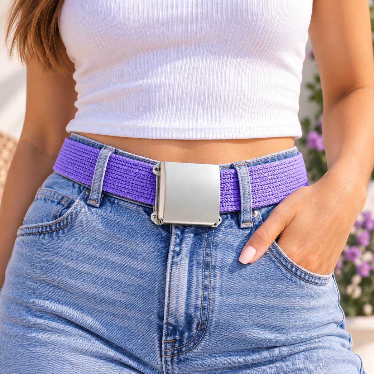 Purple woven belt with a silver buckle, worn with a white top and blue jeans.